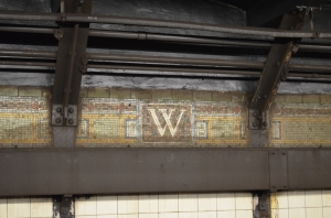 In every subway station I have seen the names of the stations have been in tiles like this